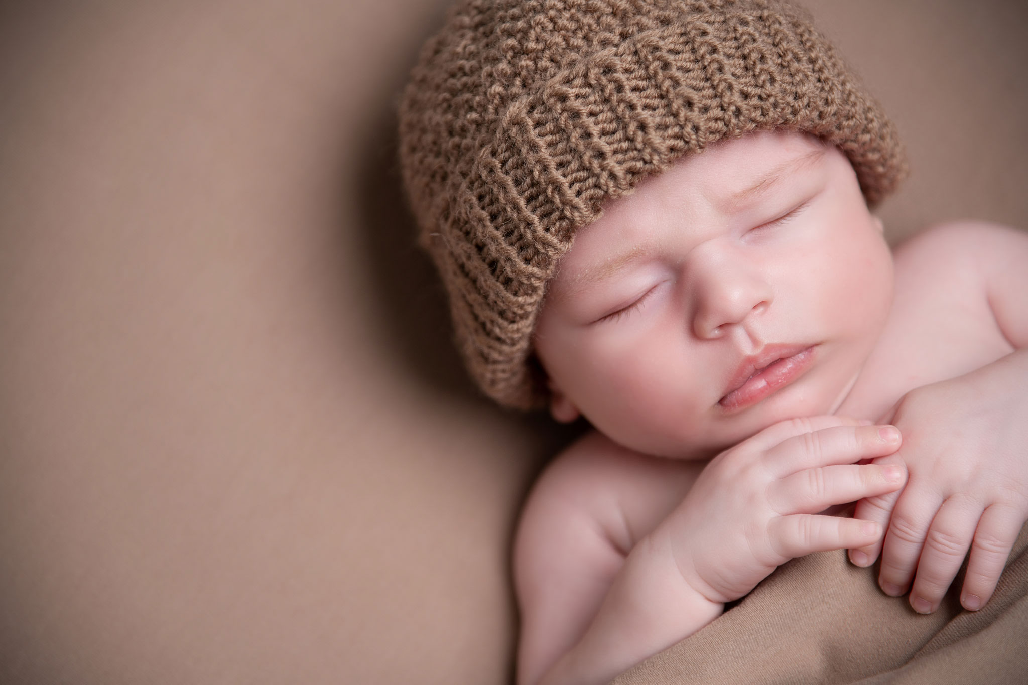 Hampshire newborn photographer NK Photography baby photos hampshire (6) baby in brown hat on blanket posed photography - newborn photographer Hampshire baby photos NK Photography