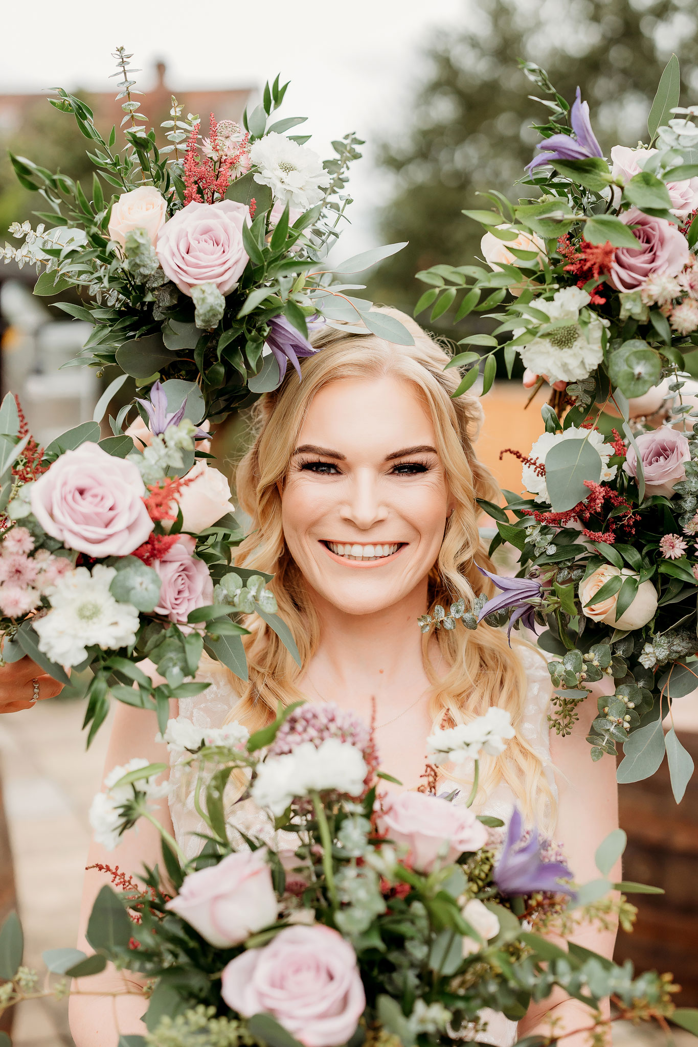 a lovely smile from the bride surrounded by flowers