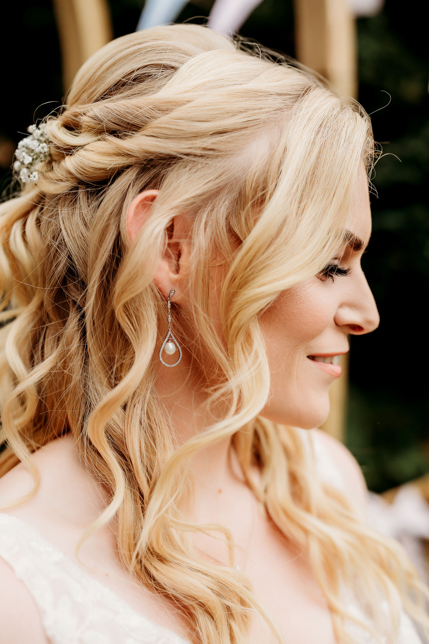 a close up of the brides earring and hair