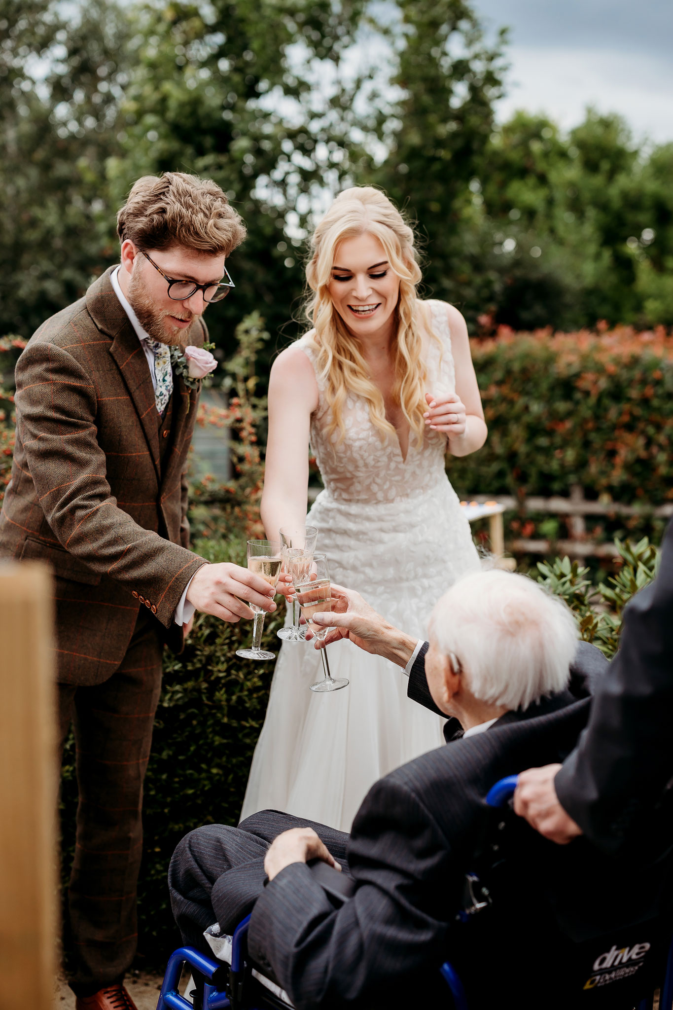 the bride and groom cheering with their granddad