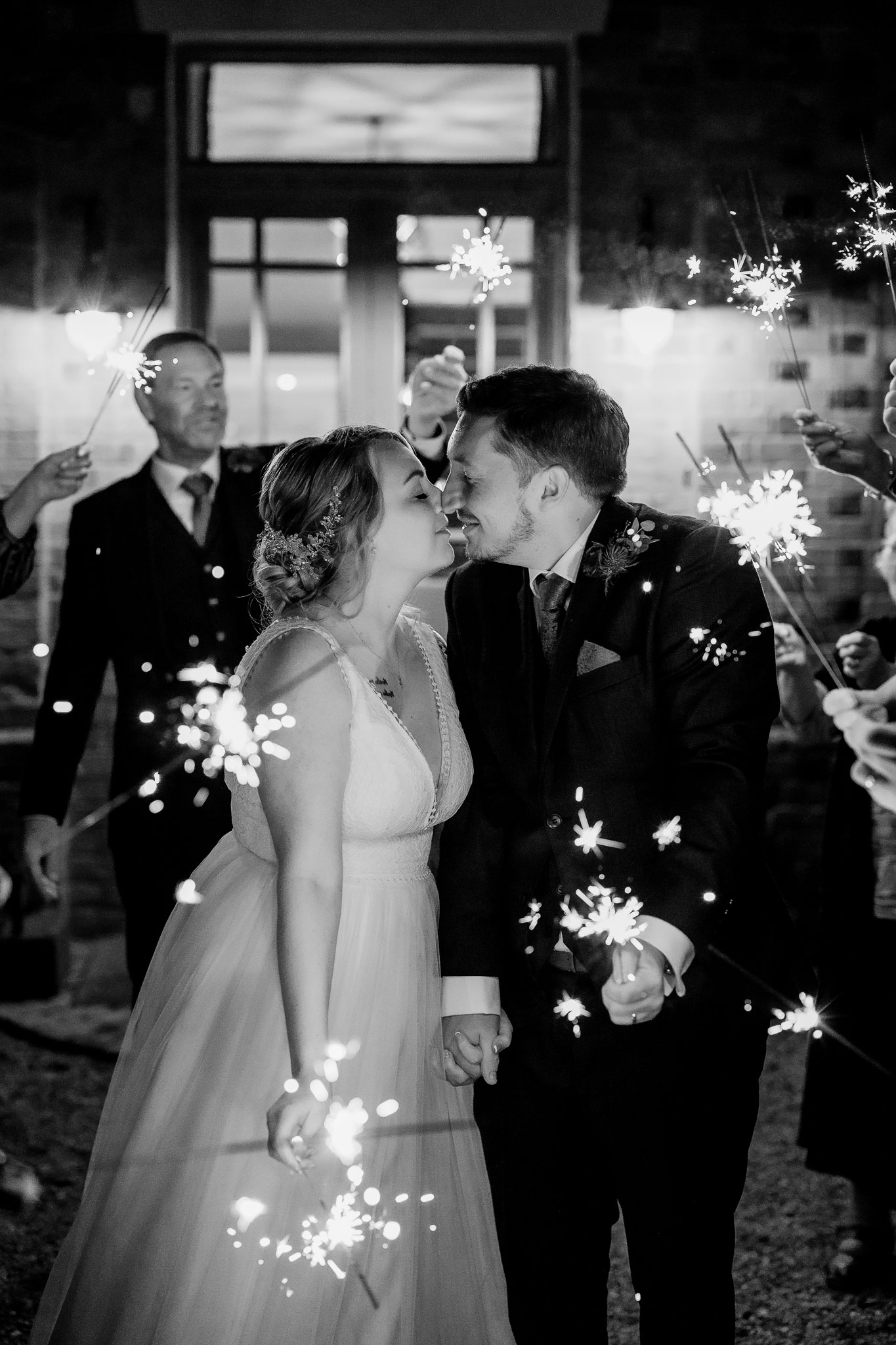 the bride and groom surrounded by sparklers