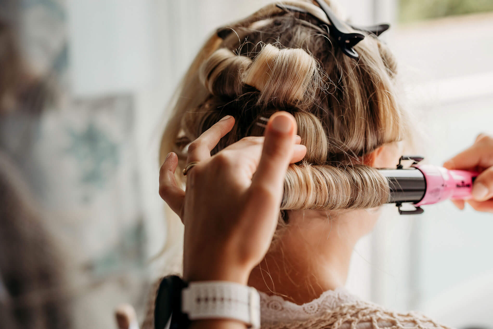 a bride getting her hair done for her wedding