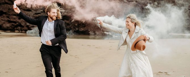 a bride and groom using smoke bombs