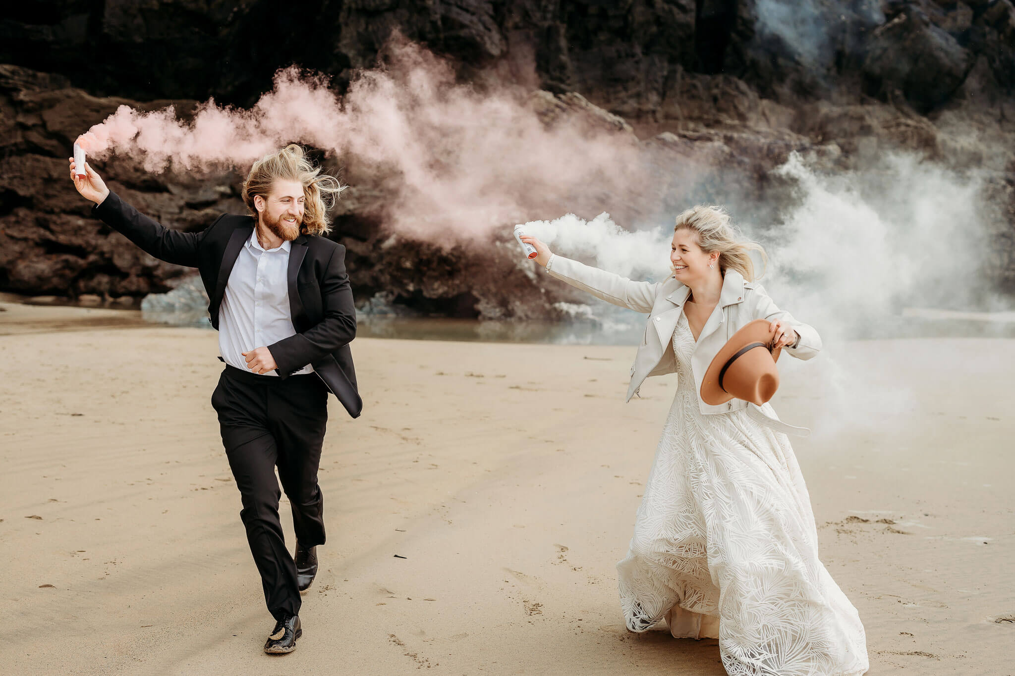 a bride and groom using smoke bombs
