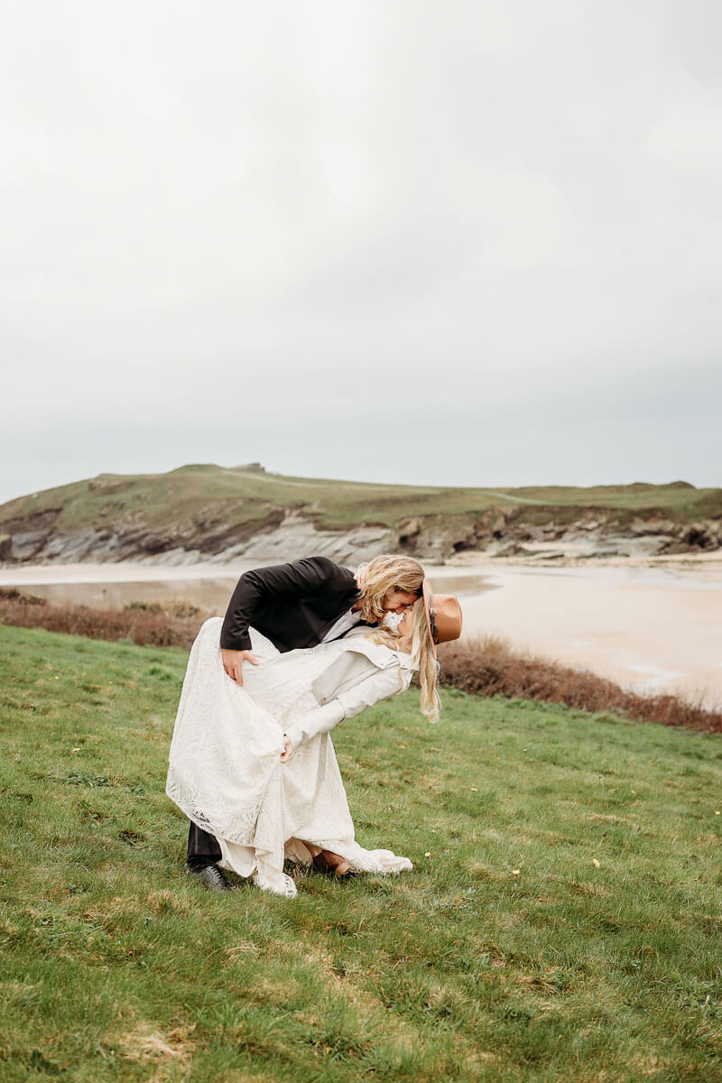 a bride and groom on a clifftop in Cornwall