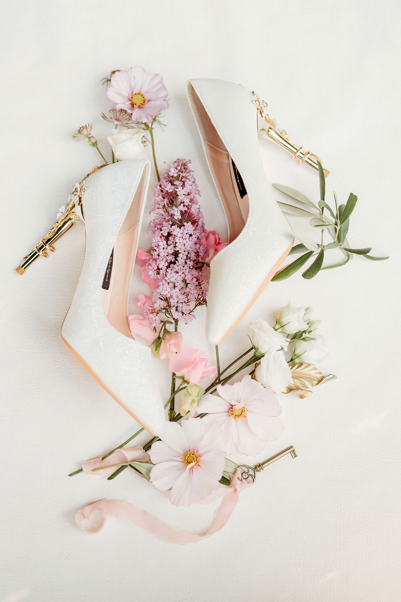 a brides shoes with her flowers