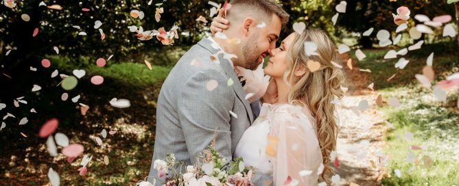 a bride and groom kissing in confetti