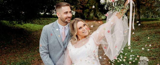 a bride and groom smiling with confetti