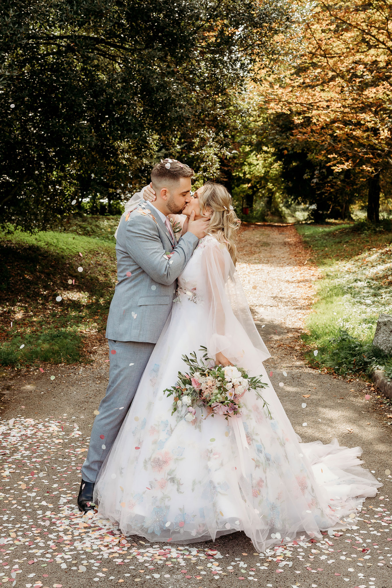 a bride and groom kissing at lainston house in confetti