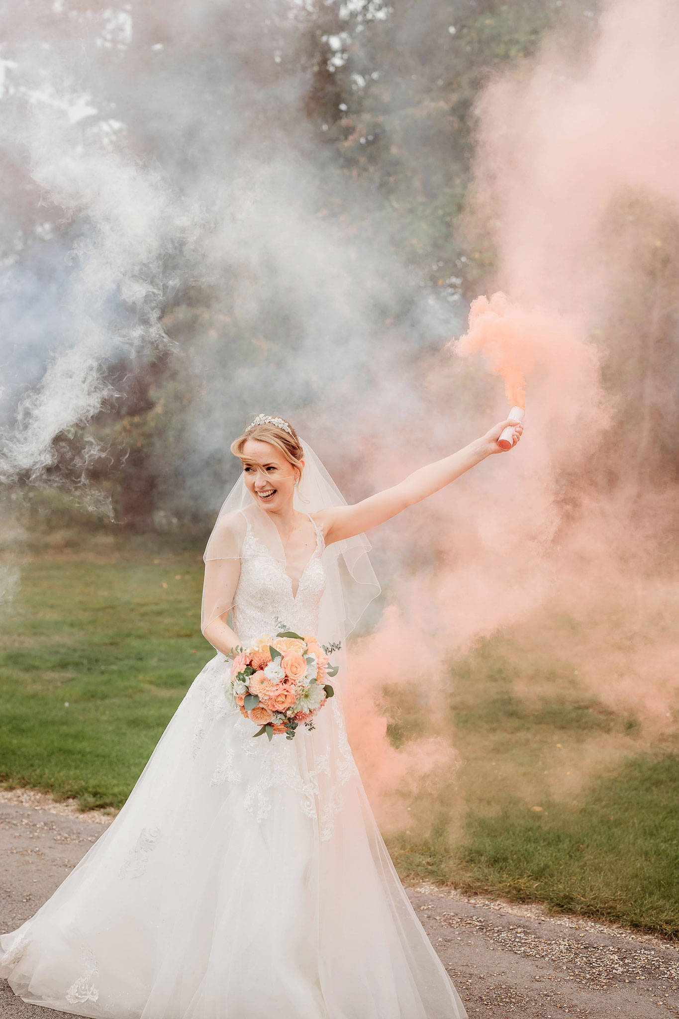 the bride celebrating with a pink smoke bomb