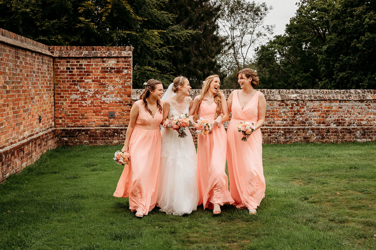 the bride and her bridesmaids wearing peach dresses
