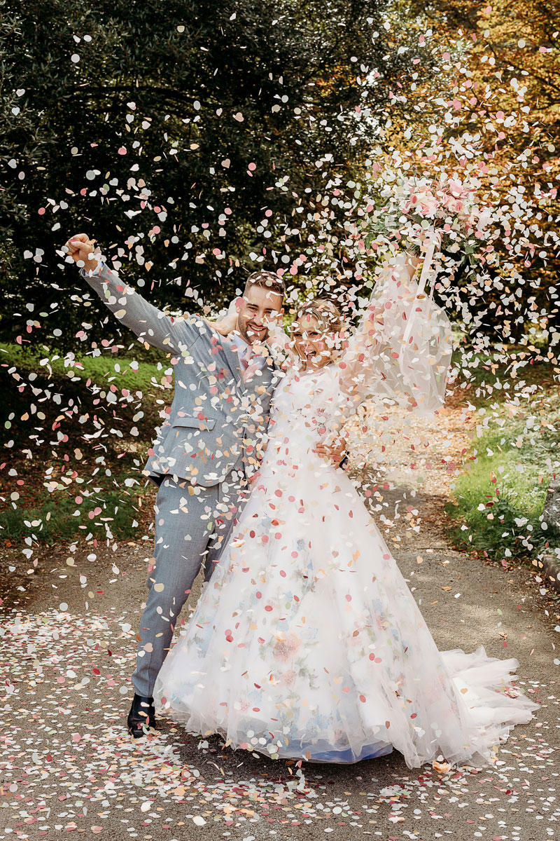 a bride and groom enjoying their confetti photo