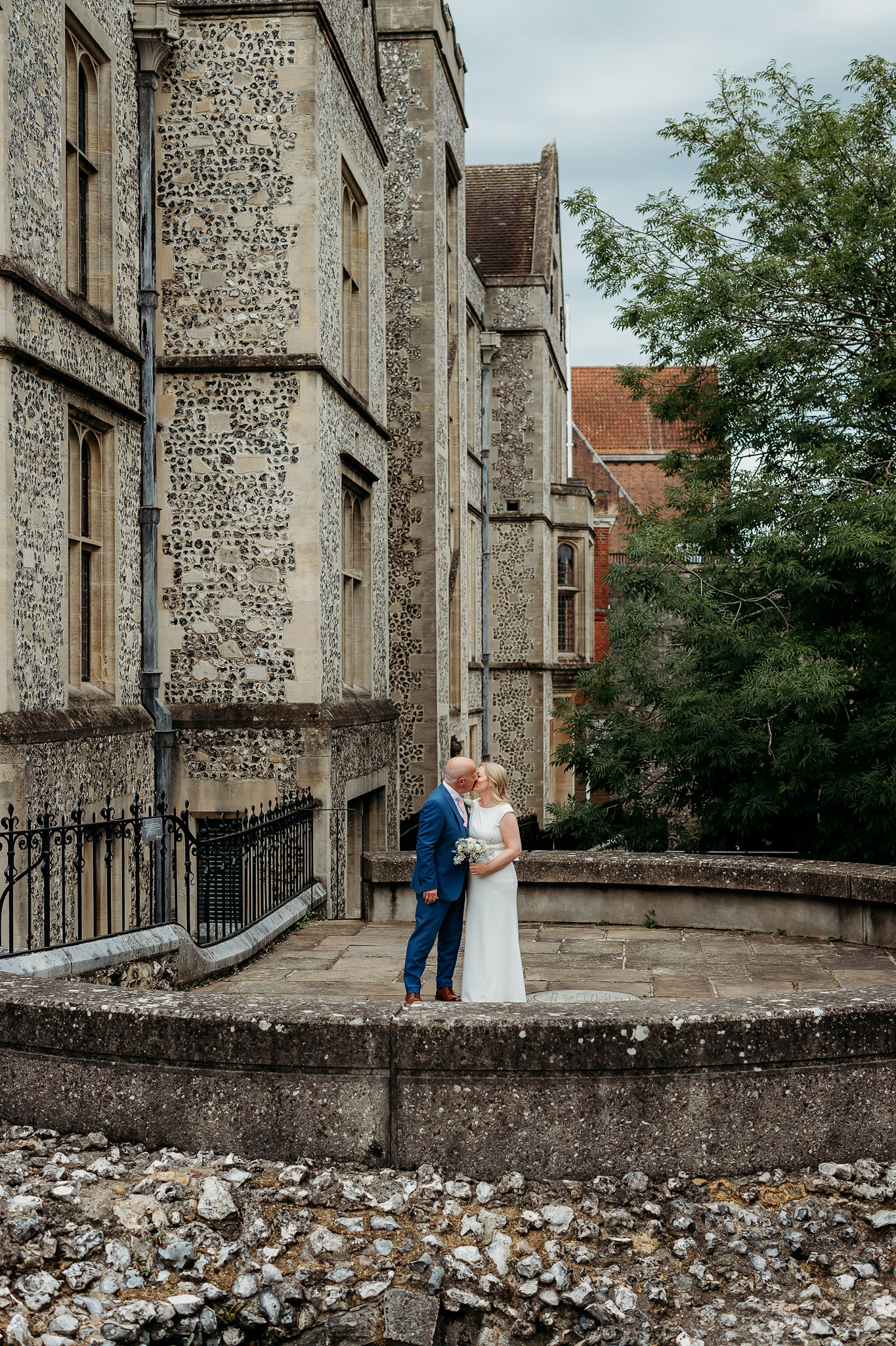 a bride and groom kissing at Winchester registry office