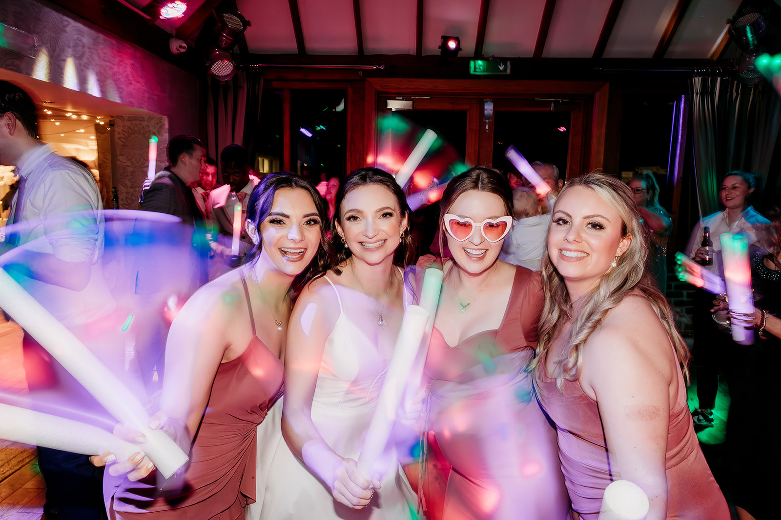 the bride and her girls glow stick wedding party photos