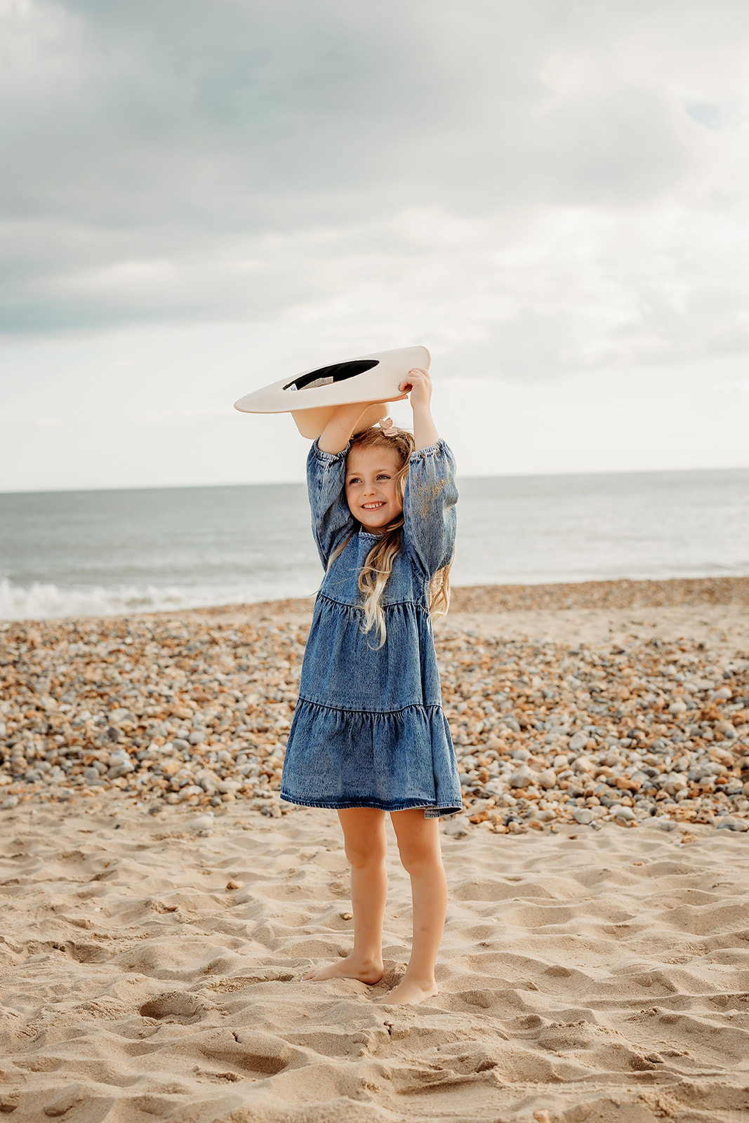 a child on the beach having her picture taken by a Hampshire family photographer