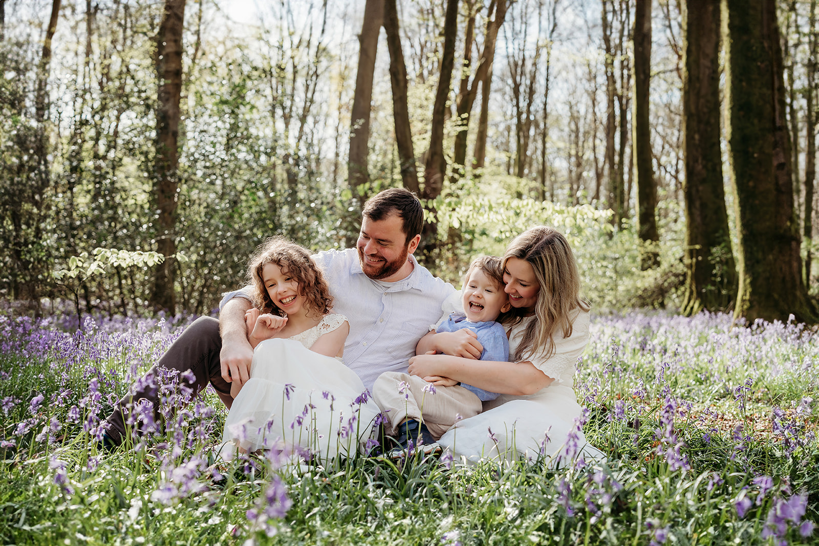 a family having a photoshoot in the bluebells captured by a Hampshire family photographer