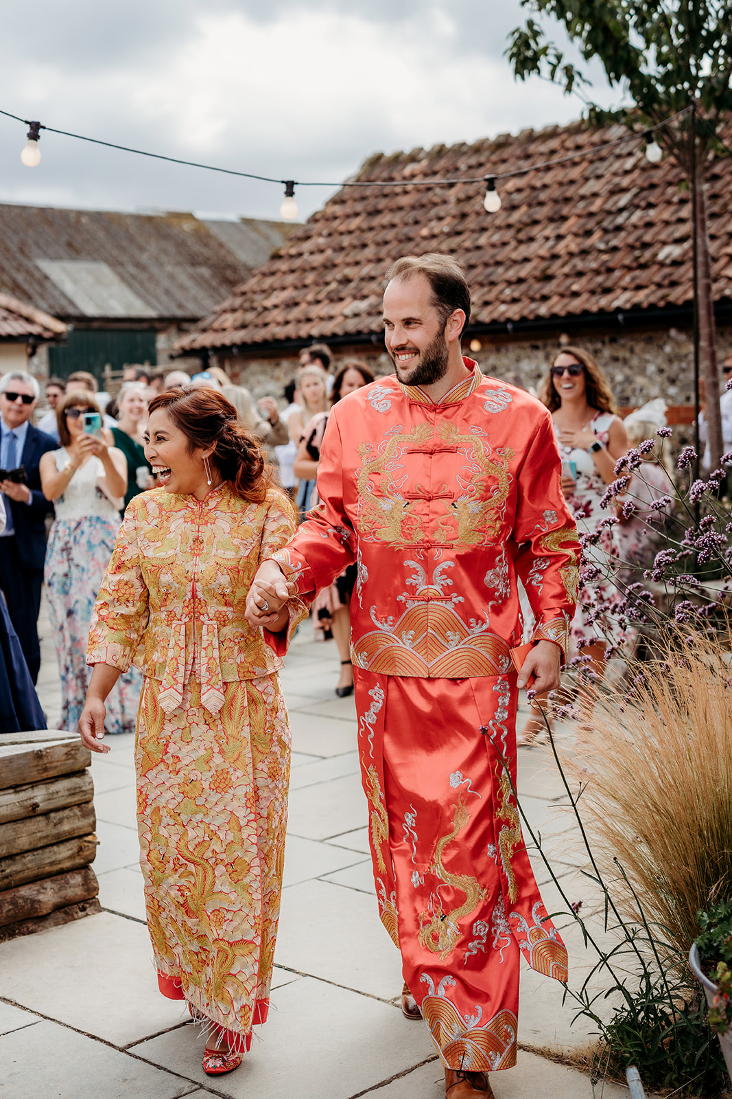 a bride and groom changing into Chinese robes for their wedding, captured by a Hampshire wedding photographer