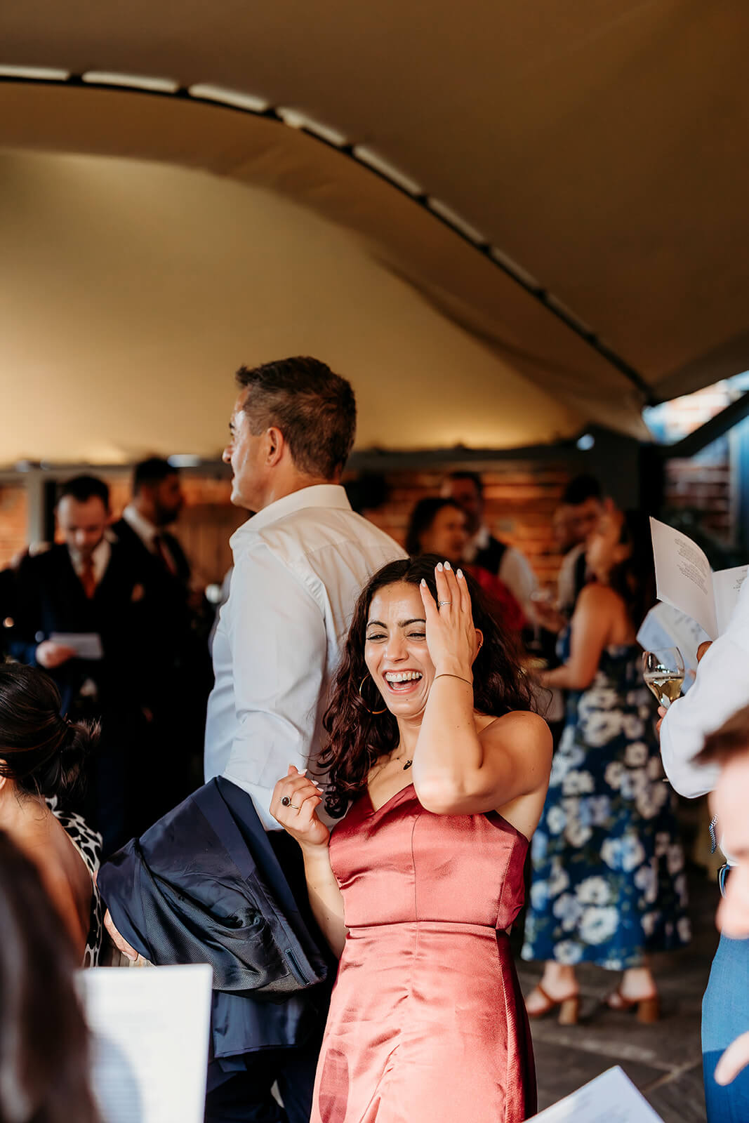 guest laughing at a wedding at wasing house