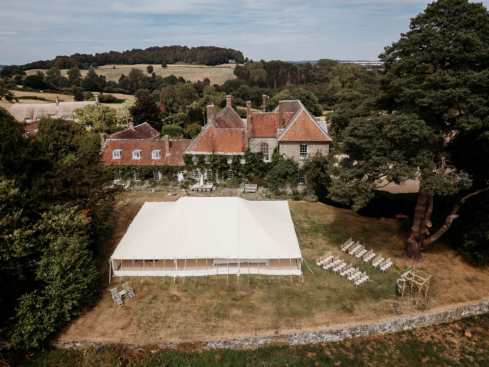 arial photo of a garden wedding a drone photo of a garden wedding with a marquee
