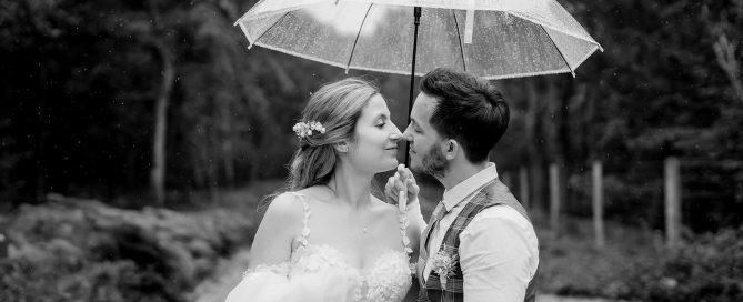 bride and groom walking in the rain