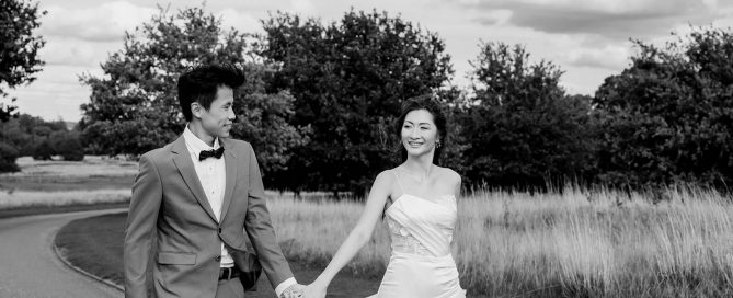 couples running in the road towards a hampshire wedding photographer