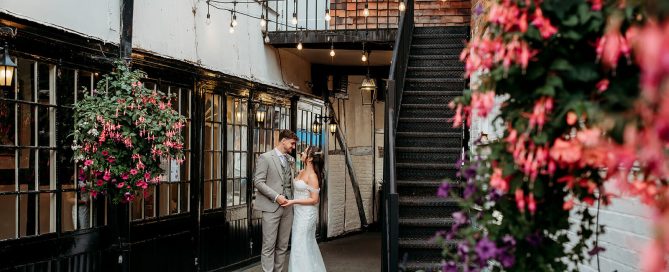 bride and groom enjoying romseys beautiful surroundings having their photo taken