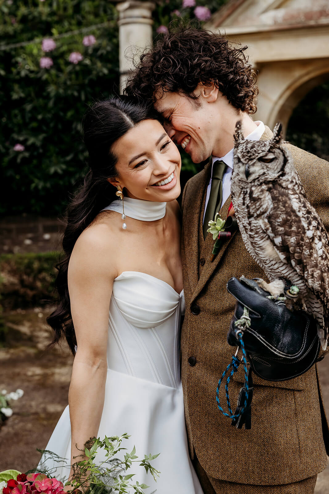 bride and groom laughing with an owl