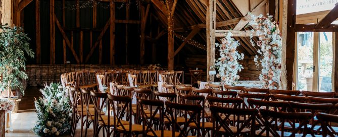 an inside wedding ceremony setup at Silchester Farm in a horseshoe shape